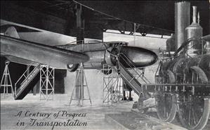 A plane and a locomotive on display in a hangar
